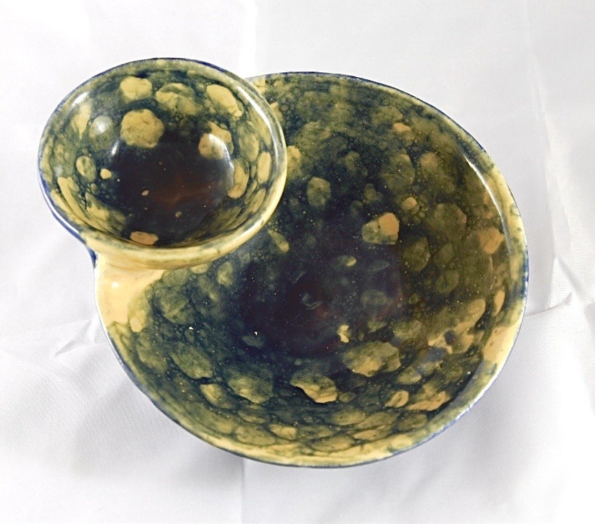 Empty blue and yellow ceramic chip-and-dip bowl viewed from above