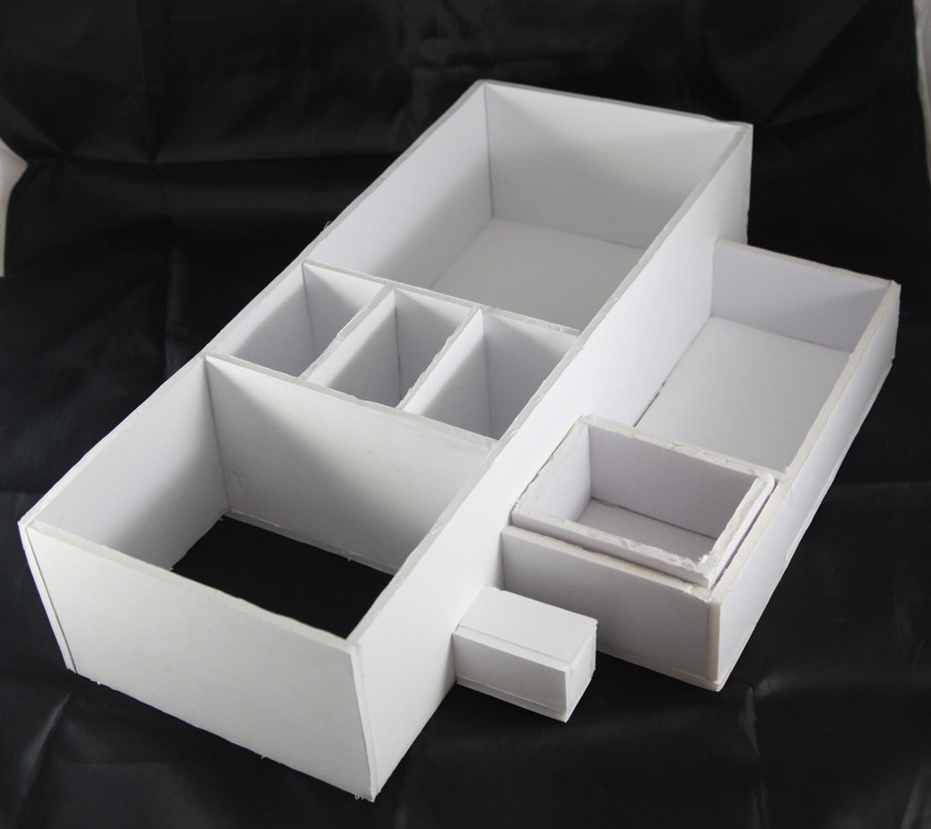 Refined desk organizer model made from white foam core with multiple compartments